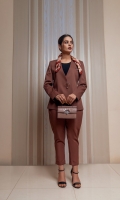 Our refined two-piece rust power suit with collarless finely modified V neckline. Ease fit blazer with ring buckle details at center front. Delicately tailored cropped pants with tapered hem and two front pockets.