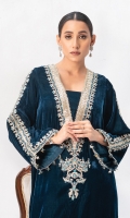 Deena features a navy-teal green Kaftan featuring ravishing embroidered details further enhanced with dainty embelishments and hanging crystal work on the slit; matching raw silk Straight Pants make it a complete look.