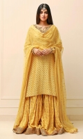 Lemon yellow cotton net shirt with a gold Hyderabadi worked neckline. A heavy spray of gold sequins on the shirt. Paired with a jamawar gharara with lace borders and a net dupatta with a spray of gold sequins.   