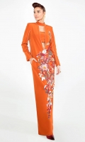 An oranged toned gown beautified by a floral splattering of pink, white and green.