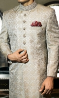 Cotton jamawar fabric sherwani designed with block print all over front panels and sleeve motifs and intricate hand embroidery on collar, sleeves and buttons. Also, highlighted with contrast fabric piping and handkerchief.