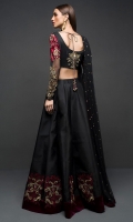 Adorned in a black choli sharara embellished with antique gold detailing on the neckline with contrasting embroidery in shades of red on sleeves and sharara, this attire will elevate your style. It comes with black net embellished dupatta.