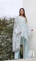 Soft aqua shirt front, back and sleeves embellished with sequin florets reminiscent of French lace paired with a slip and an Indian raw silk trouser, complimented with a lace designed resham embroidered net dupatta.