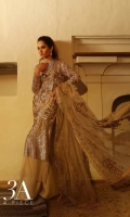 Period floral patterns carved out in copper sequin on front, back and sleeves on a delicate beige colored net provided with a slip and an Indian raw silk trouser paired with a beautiful bold floral embroidered net dupatta.