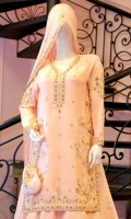 It is a mingling of elegance and tradition. A pure raw silk outfit in blush pink with hints of mauve resham work. The dress is intricately embellished with gold and silver zardoze work with pearls on a floral theme and is paired with handcrafted matching  pure raw silk lehanga with intricate hand embellishments. It is adorned and finished with banarsi in hues of pink and gota lace, worn with a flowing embroidered blush pink dupatta in medium silk with a hand embellished border and booti. A matching pouch can be made on order to complete the look.