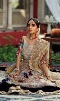 Heavily worked gold choli with colorful sleeves. It is paired with a worked lehnga with border detailing and a heavily worked scalloped dupatta.