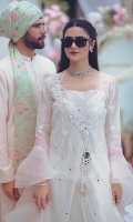 A white angrakha made of exclusively woven chiffon jacquard for Zainab Salman. It is embellished with mirrors, lace finishing and scalloped edges. The look is completed with signature ZS mirror tassels. Lawn slip included.